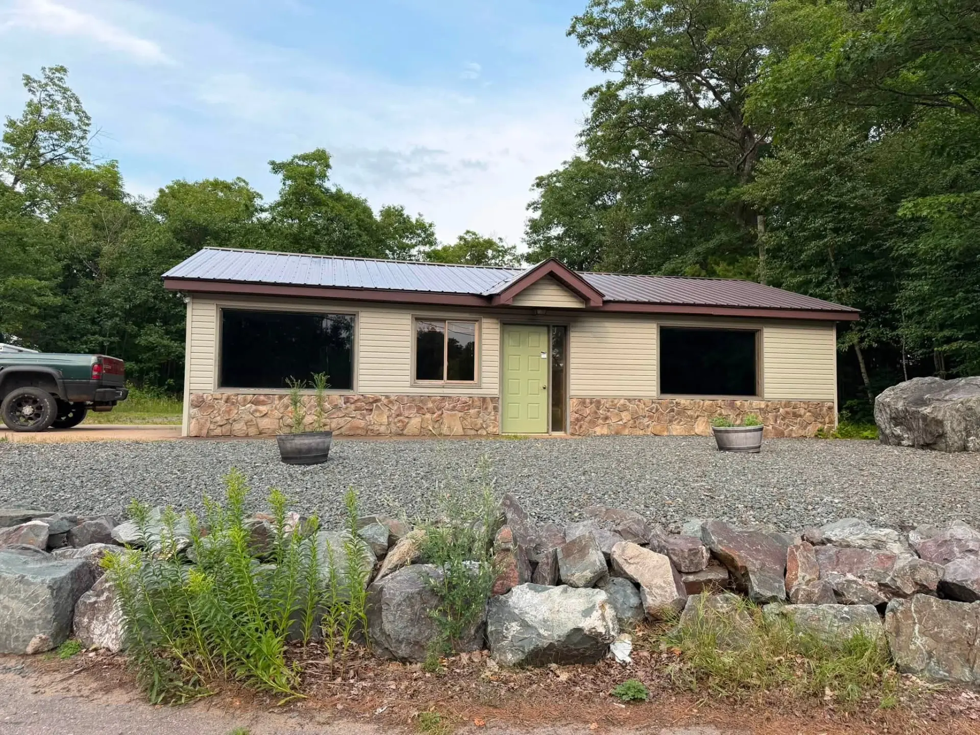 Home with vinyl siding, stone veneer and a metal roof